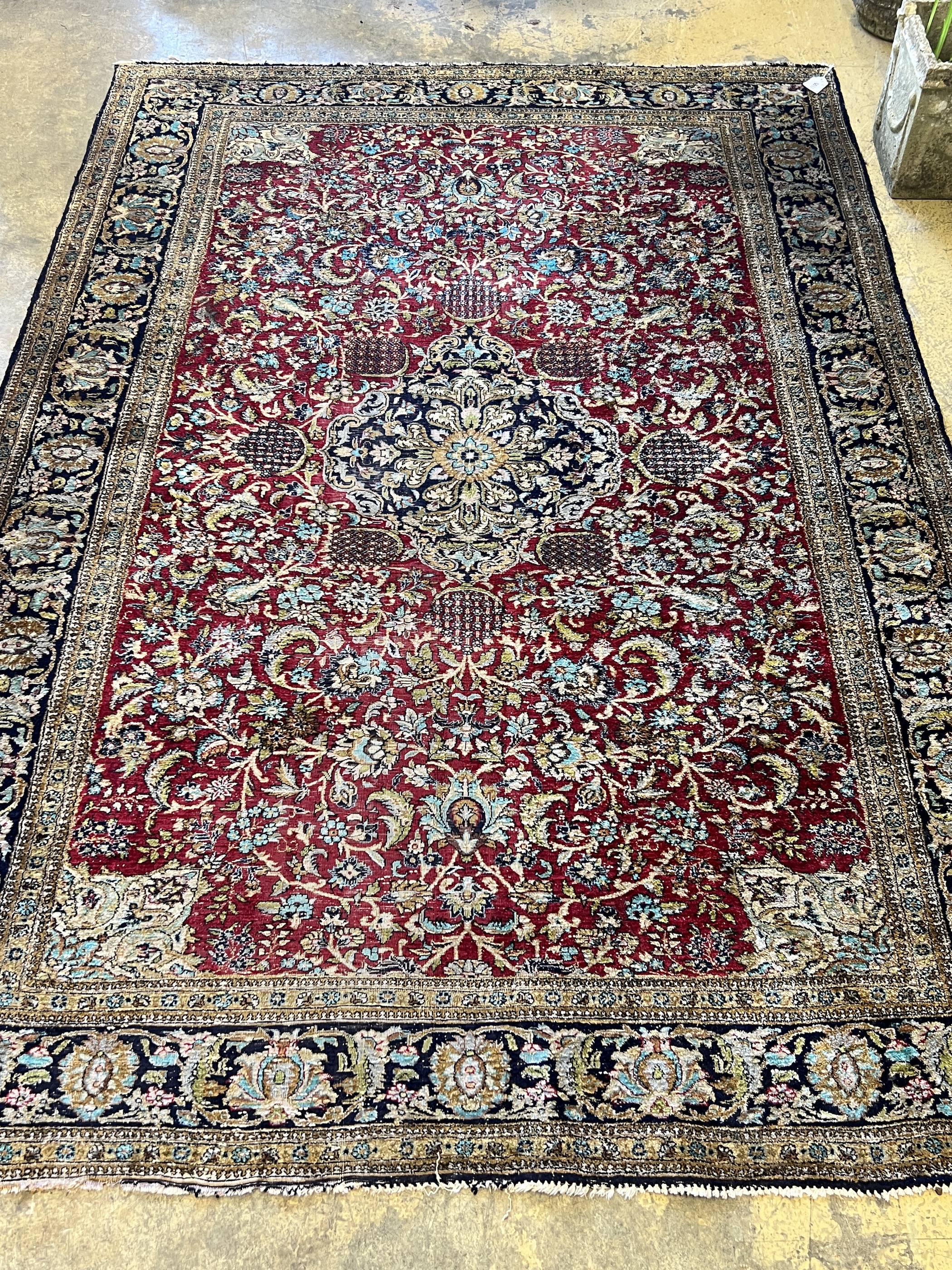A Tabriz part silk burgundy ground rug, 218 x 150cm